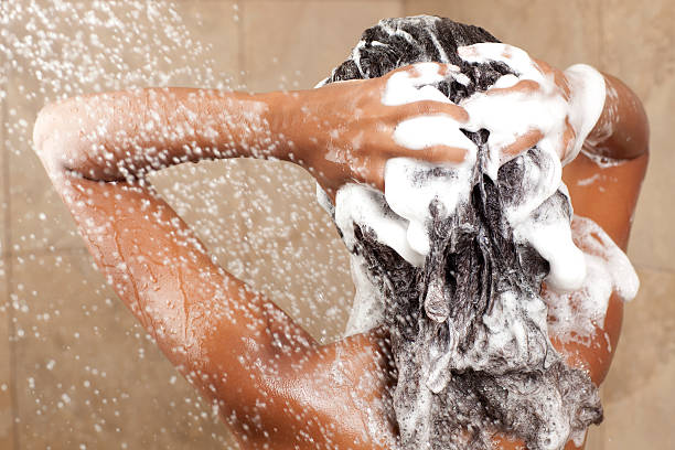 A woman doing hair care routine based on her hair porosity